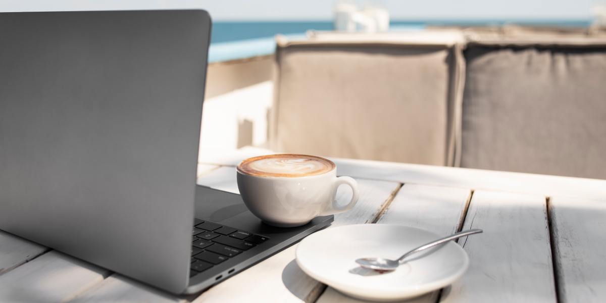 coffee-cup-and-laptop-at-seaside 1